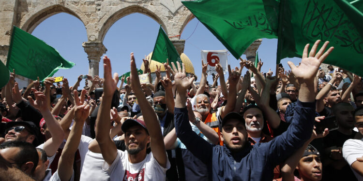 Hamas flags are displayed at the funeral of the Eli attacker